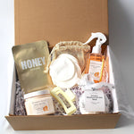 Luxury self-care gift box for ultimate relaxation and pampering. Includes a magnetic keepsake box, hydrating honey sheet mask, Sunday Rain mango & coconut hair and body mist spray, nourishing mango & coconut body butter, Energise Himalayan bath bomb, reusable face cloths in a bamboo bag, and a stylish claw hair clip. Perfect for birthdays, self-care gifts, and spa gift sets.
