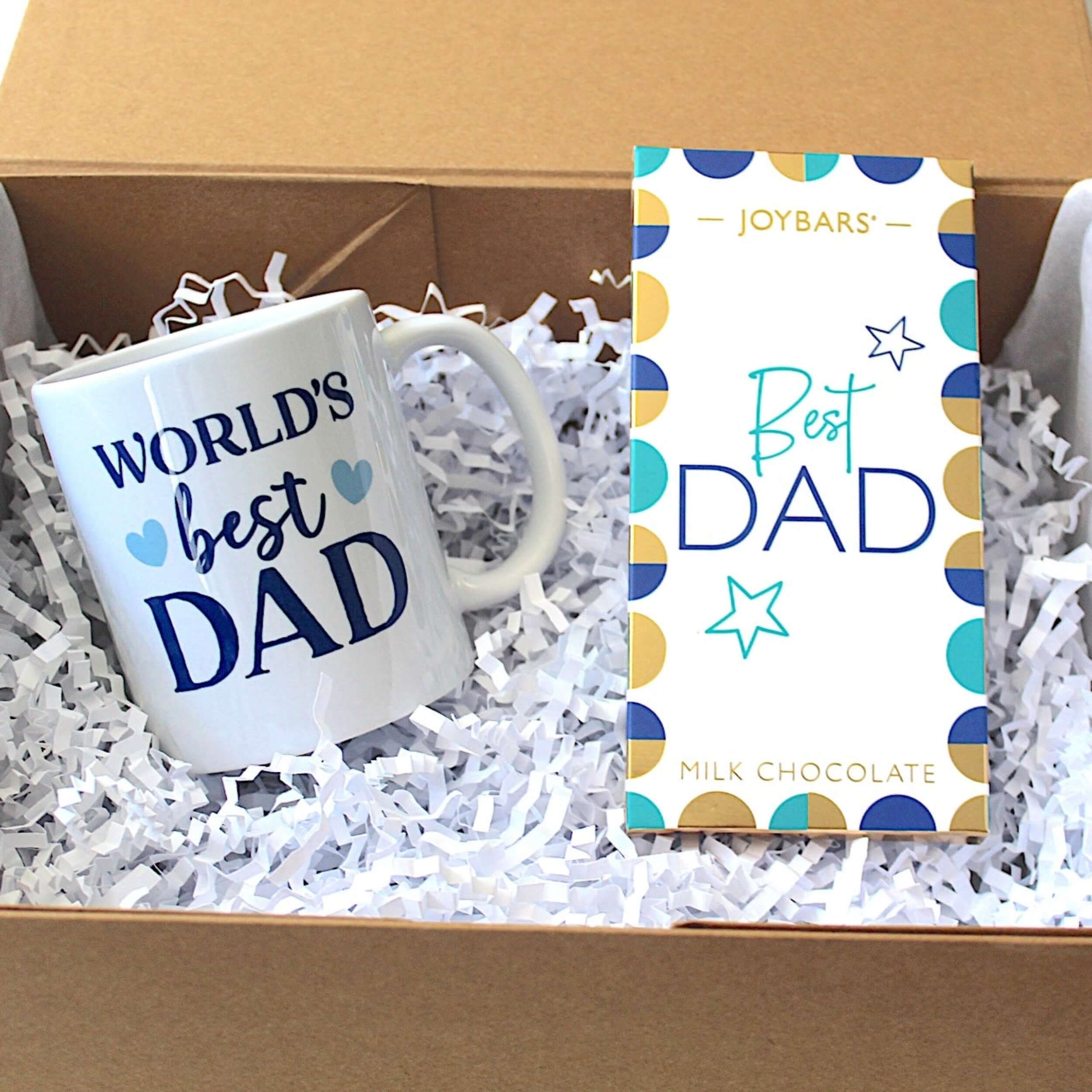 Father's Day gift featuring a mug that says 'World's Best Dad' and a chocolate bar labeled 'Best Dad'.