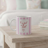 Am just a girl mug on a wooden table with pink stripes and an empowering quote.