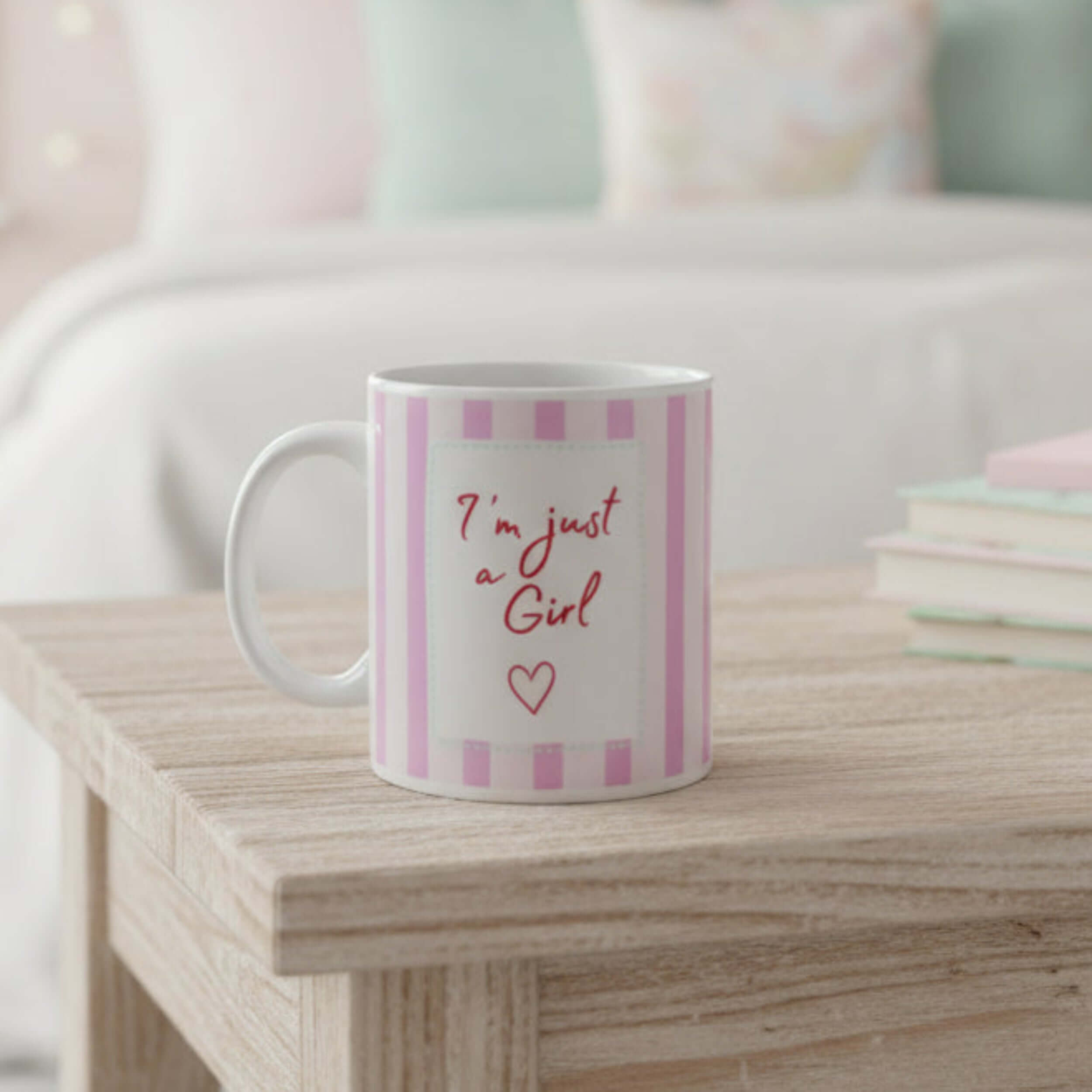 Am just a girl mug on a wooden table with pink stripes and an empowering quote.