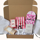 A curated gift box set containing a pink and white striped bag of Francesca Rose gel nails, a pink and white bubble tea sheet mask from Bubble Tees, a soy wax melt bar, a Happy Birthday card, and a Happy Birthday note, all arranged inside an open brown cardboard box with white tissue paper and crinkle paper filler.
