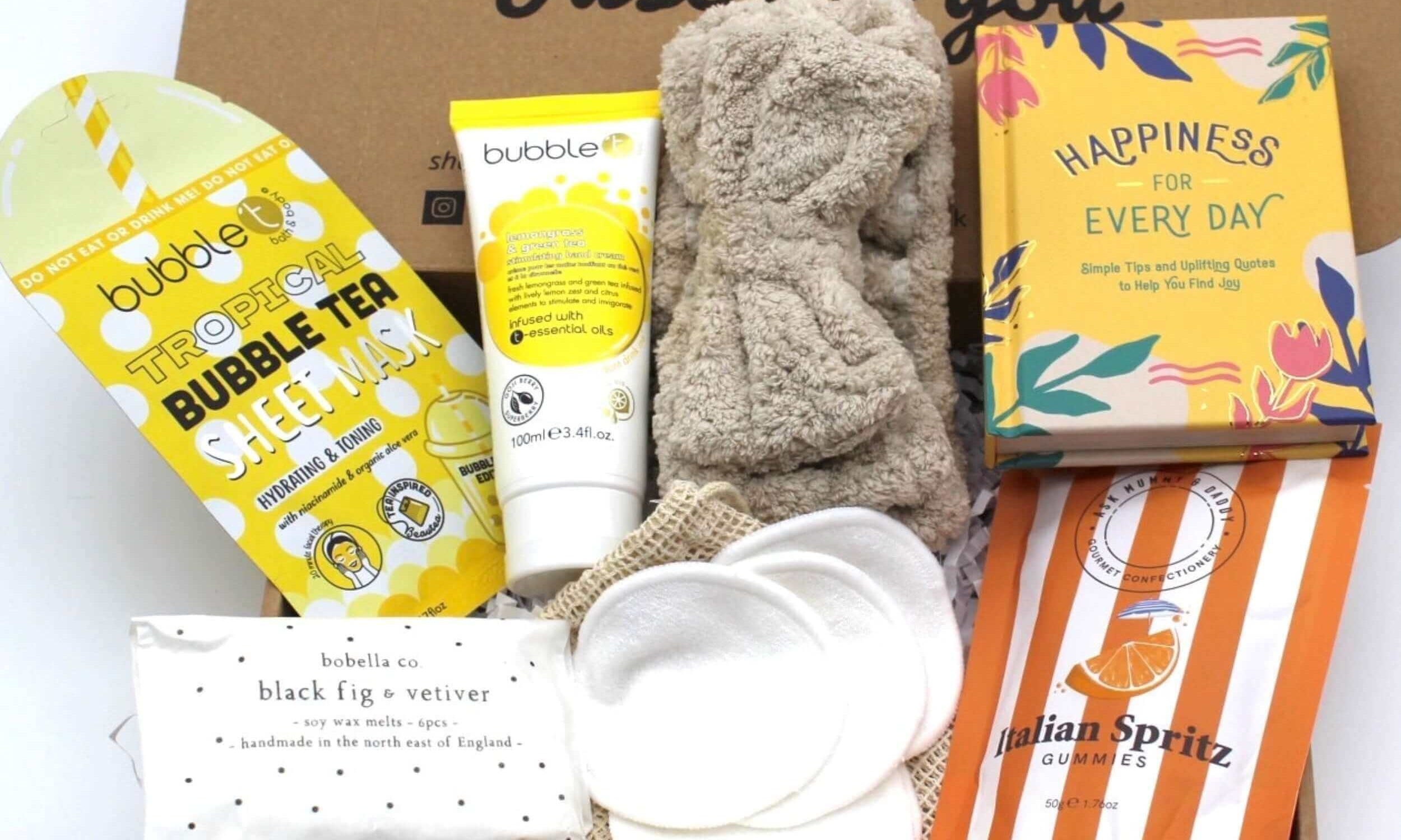 Letterbox gift full of bright treats to bring happiness to their day. Includes quote book, sap headband, sheet face mask, yummy sweets, reusable face cloths and wax melts.