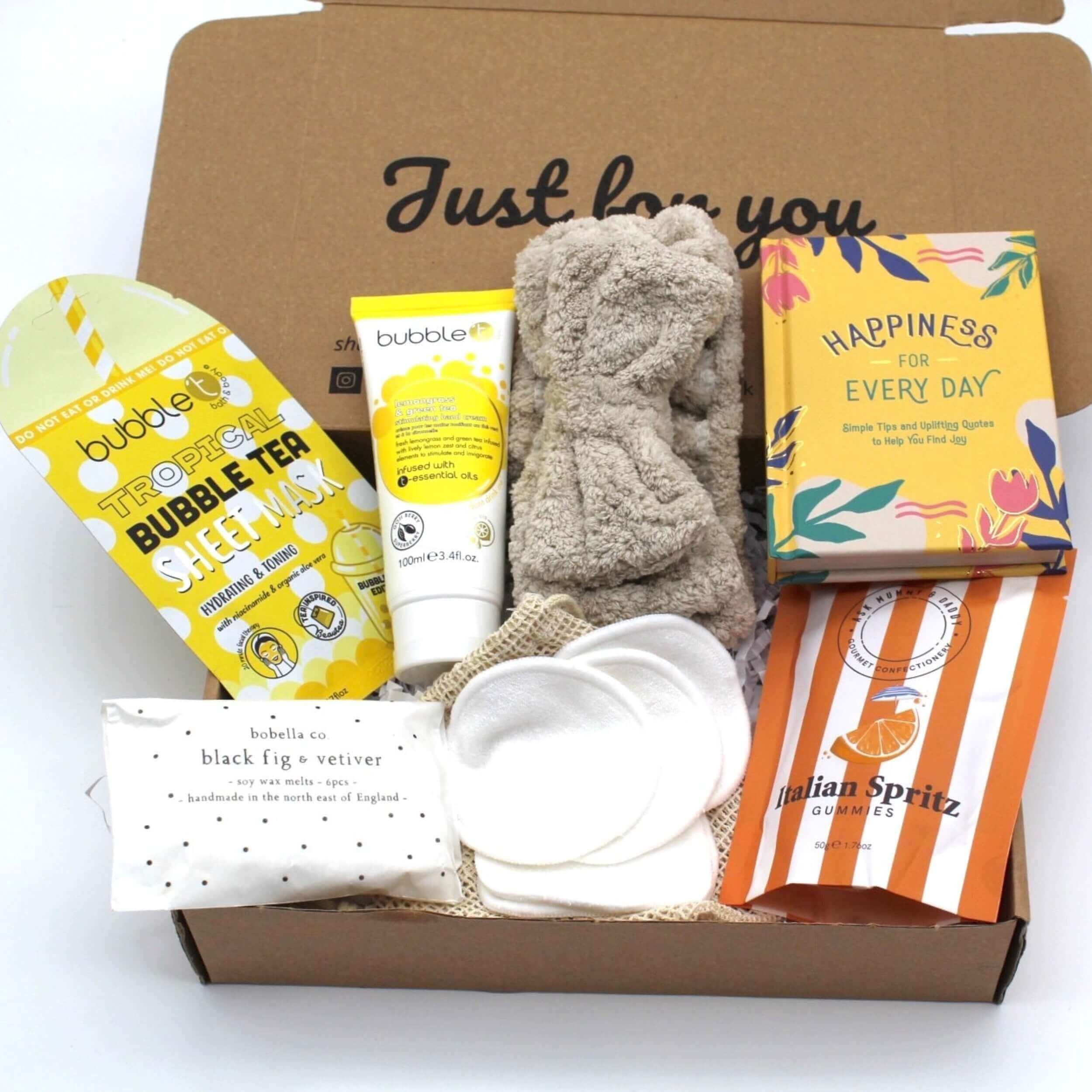 Letterbox gift full of bright treats to bring happiness to their day. Includes quote book, sap headband, sheet face mask, yummy sweets, reusable face cloths and wax melts.