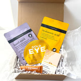 Golden Christmas pamper gift box with hand mask, hyaluronic acid face mask, gold eye patches, bath bar and caramel lip balm