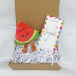 Congrats Plush gift set featuring watermelon plush, congratulations card, and Colombian chocolate in gift box.