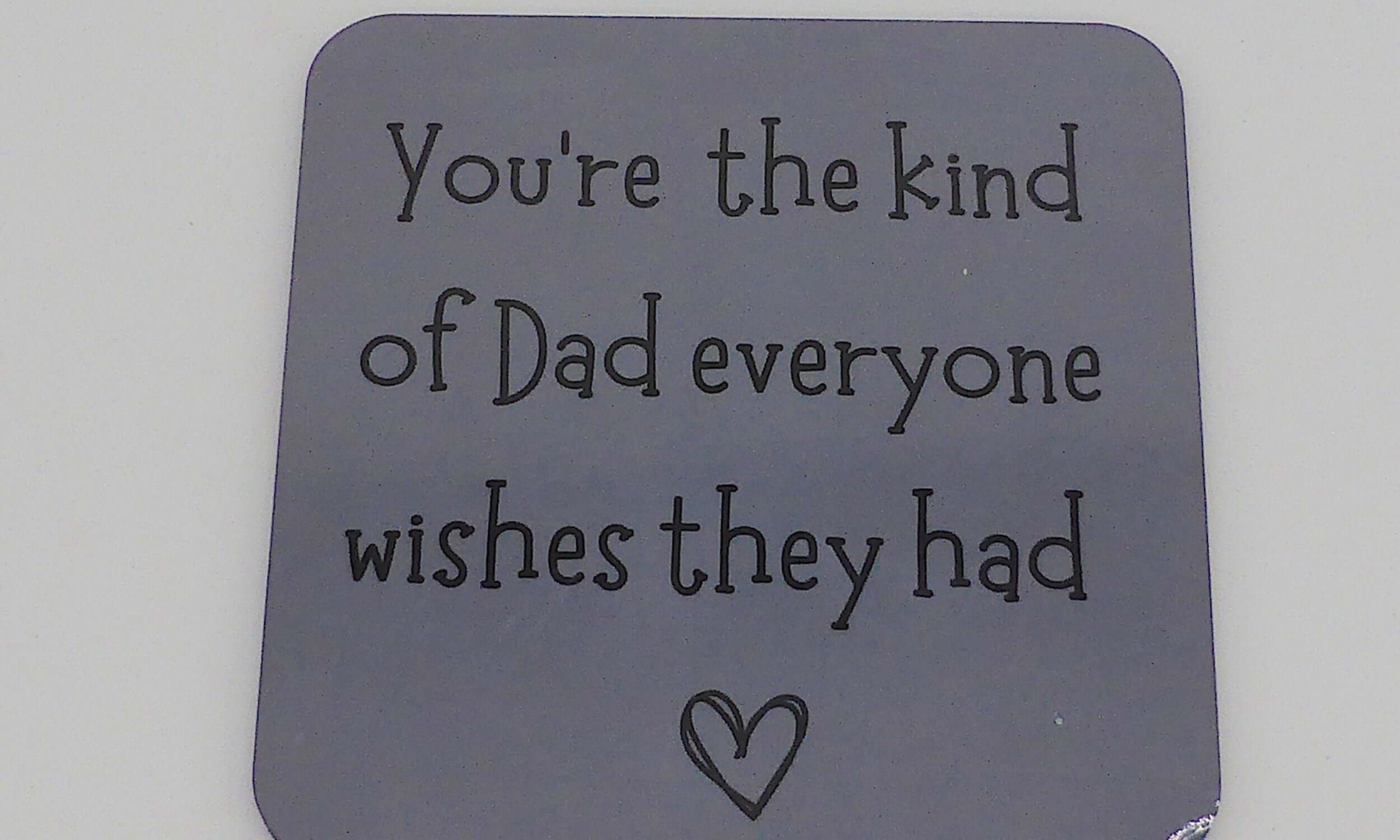 Gray coaster with text and heart on a gray background