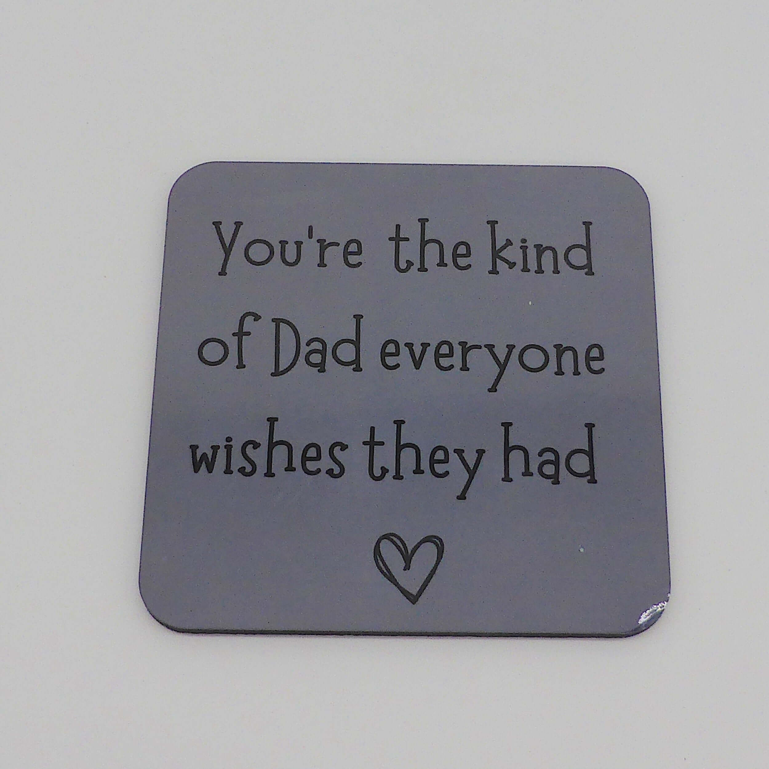 Gray coaster with text and heart on a gray background