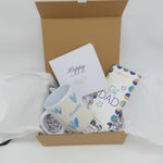 Best Dad Gift Set with a ceramic mug, chocolate bar, and greeting card in a gift box.
