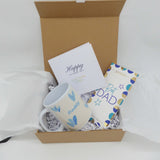 Best Dad Gift Set with a ceramic mug, chocolate bar, and greeting card in a gift box.