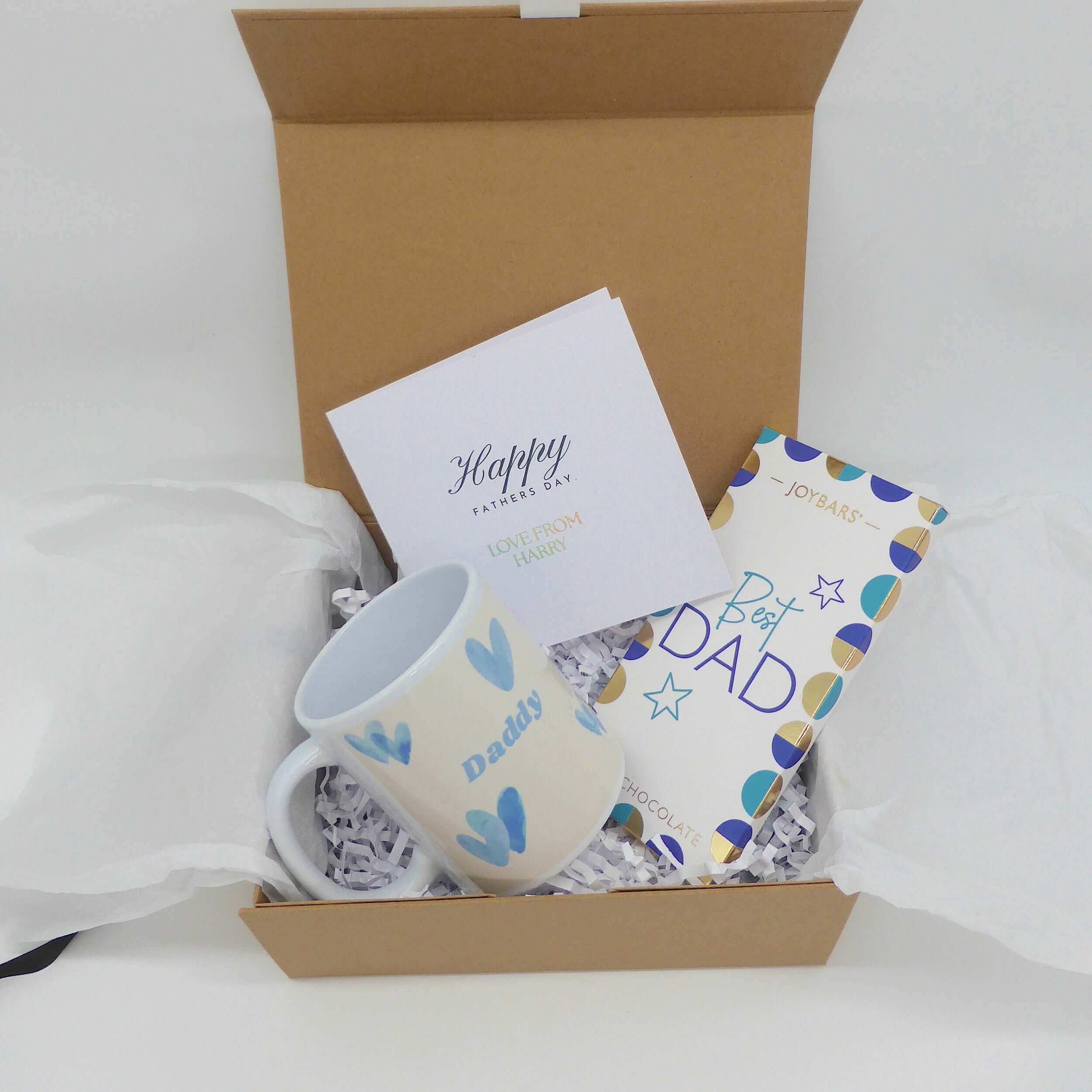 Best Dad Gift Set with a ceramic mug, chocolate bar, and greeting card in a gift box.