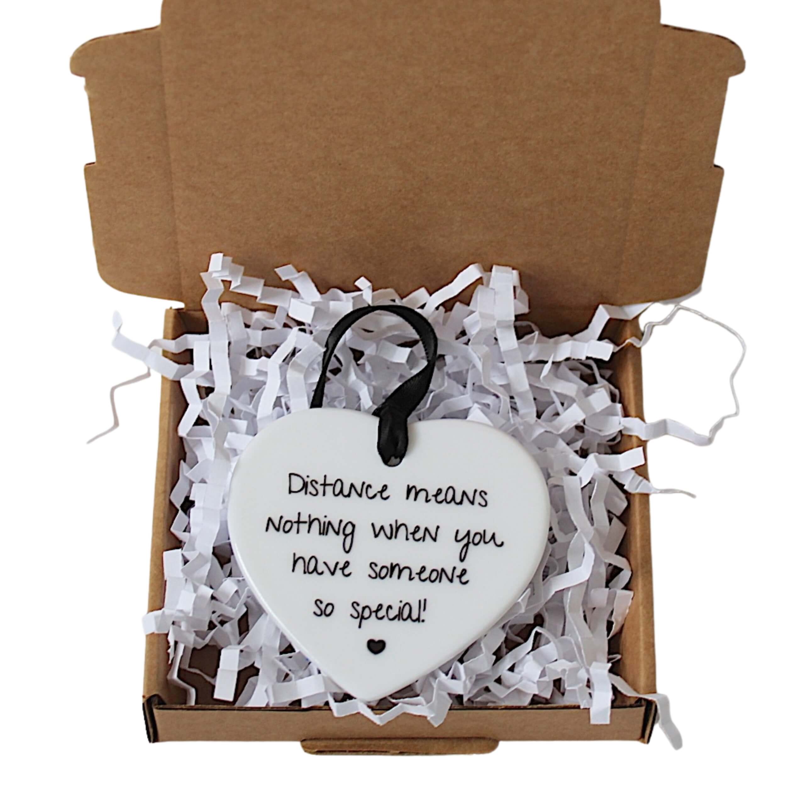 Ceramic keepsake white with black font saying distance means nothing when you have someone so special, Presented in craft gift box on white tissue paper. 