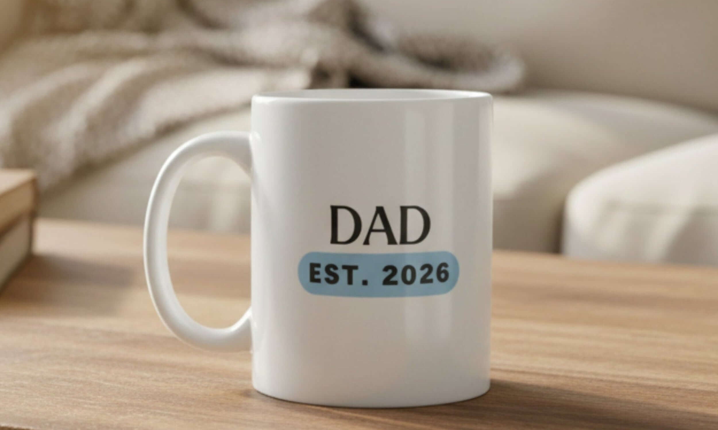 Dad EST. 2026 ceramic mug resting on a wooden table, perfect gift for new fathers.