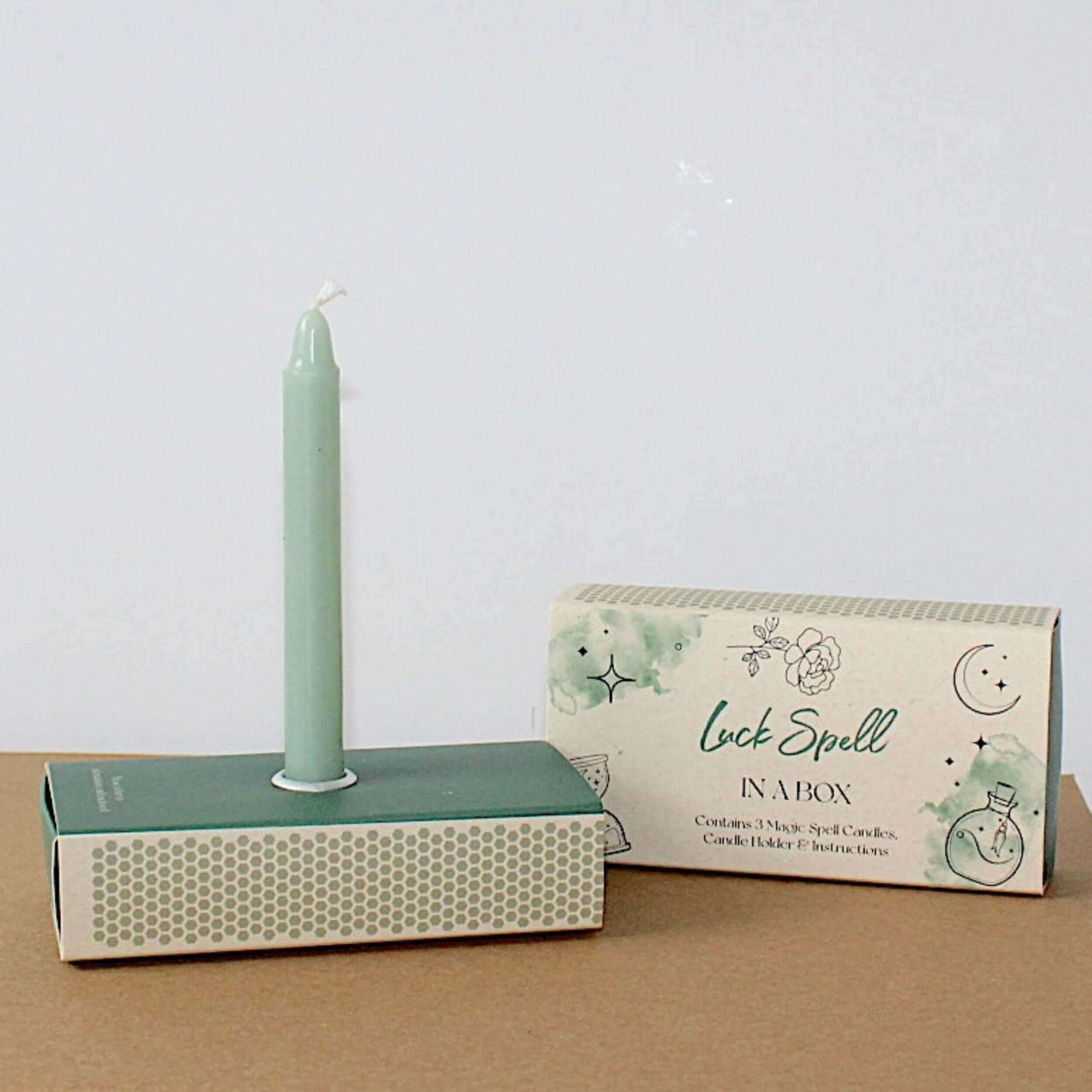 Good luck wish candles, light green candle mounted in the stand 