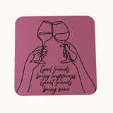 A square pink coaster with rounded corners featuring a black line art illustration of two hands holding wine glasses in a toast, with the text 'Good friends bring happiness Great friends bring wine' in black script.
