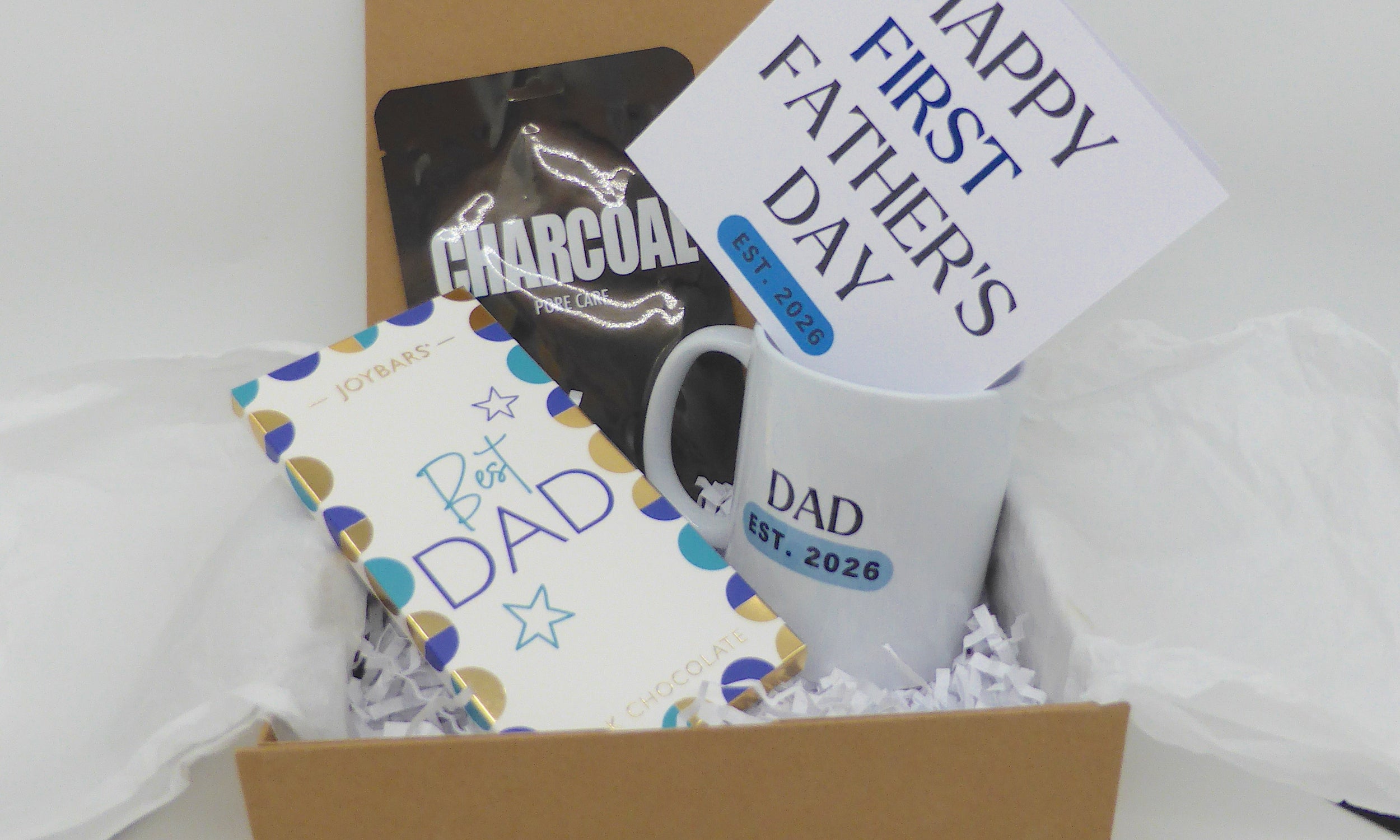 Happy first fathers day gift box, mug, matching card, charcoal sheet mask and Best Dad chocolate bar. 