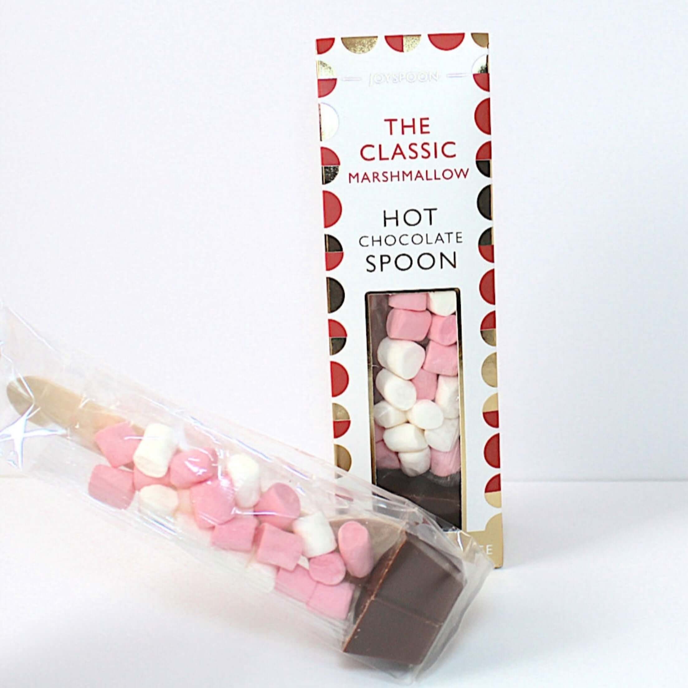 Hot chocolate spoon with marshmallows in a decorative packaging on a white background