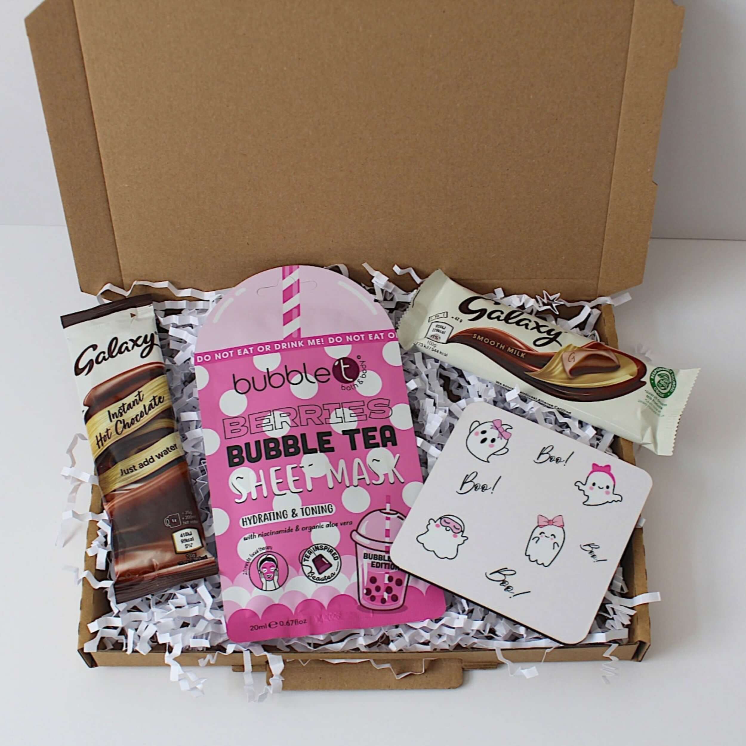 Box containing bubble tea- berries hydrating sheet mask and Galaxy chocolate bars on a white background.