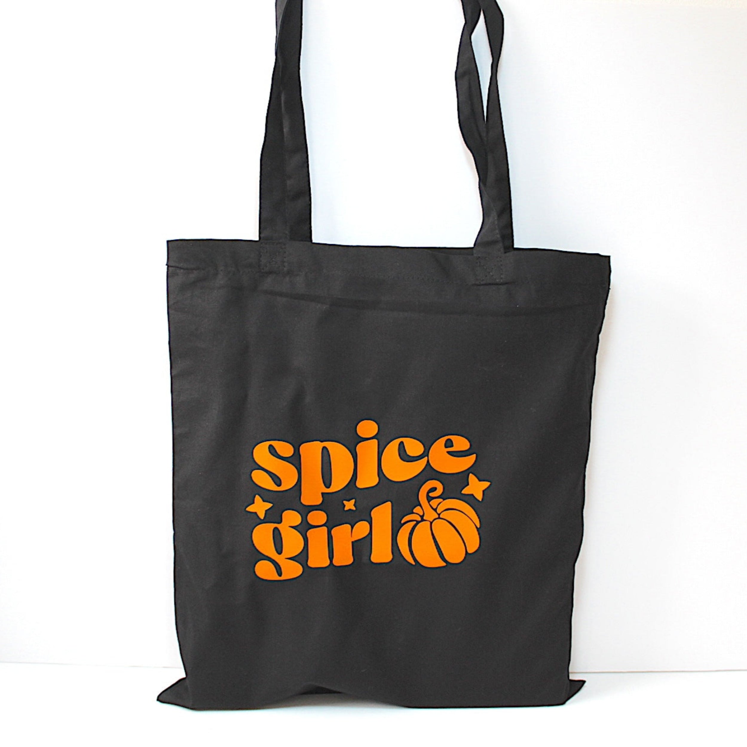 Black tote bag with 'spice girl' and pumpkin design in orange on a white background