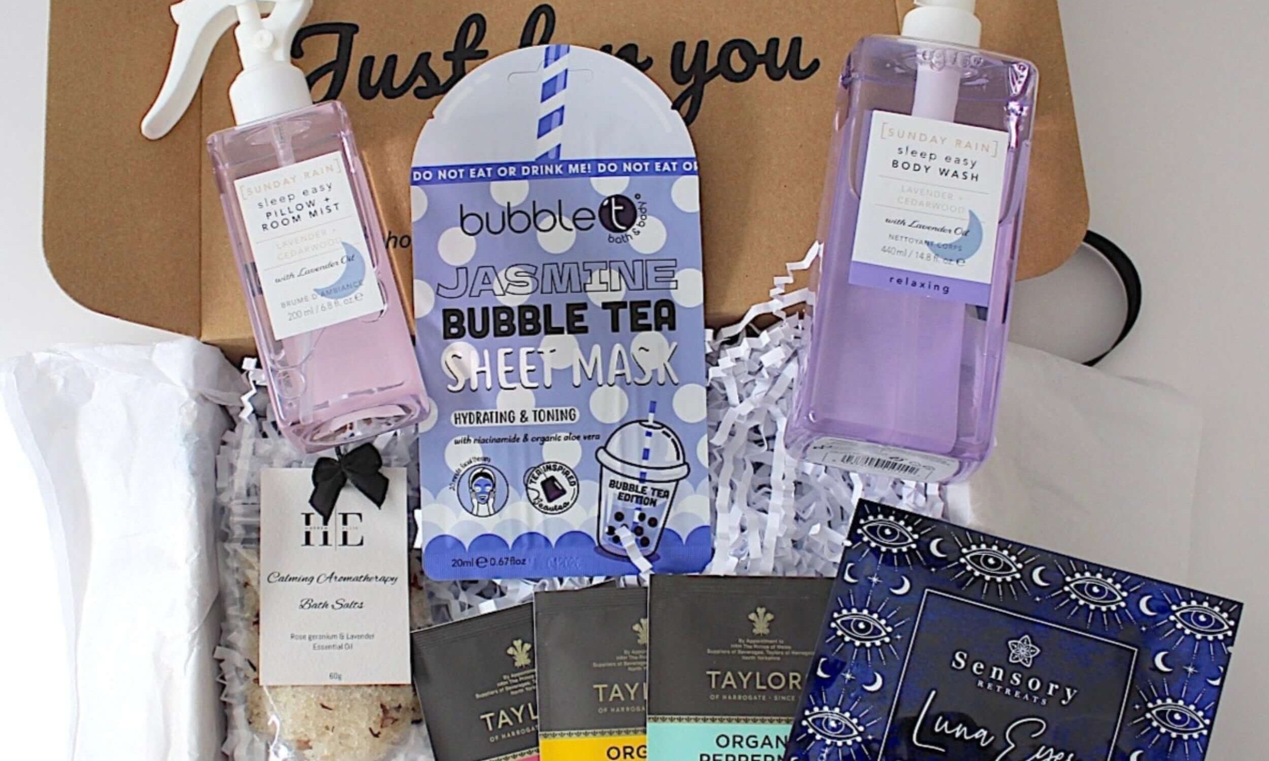 Box of skincare and wellness products including a bubble tea sheet mask, eye masks, and other items.