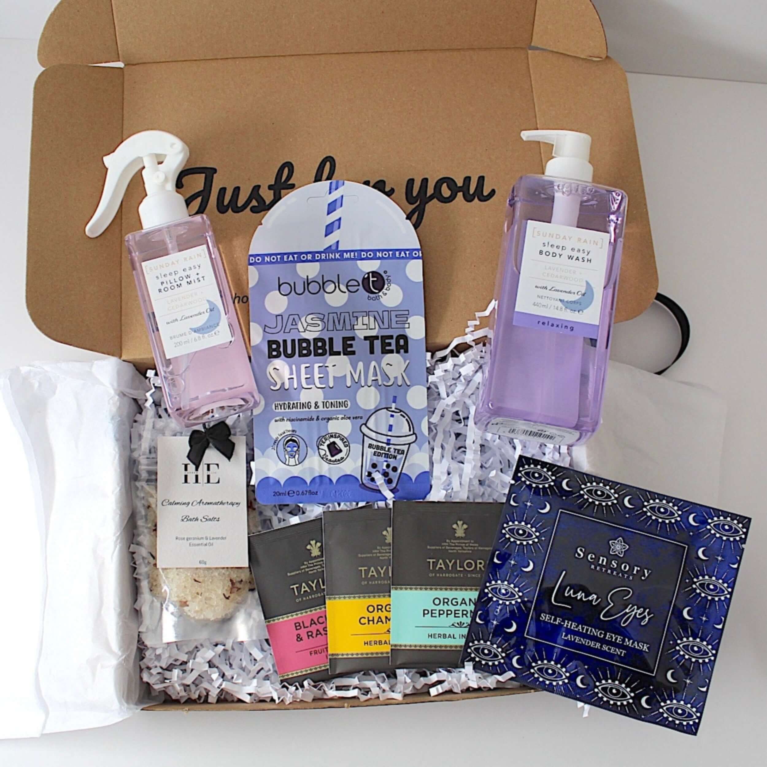 Box of skincare and wellness products including a bubble tea sheet mask, eye masks, and other items.