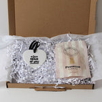 Letterbox friendly gift ceramic heart keepsake, prosecco gummies on shredded tissue paper, inside a gift box.  