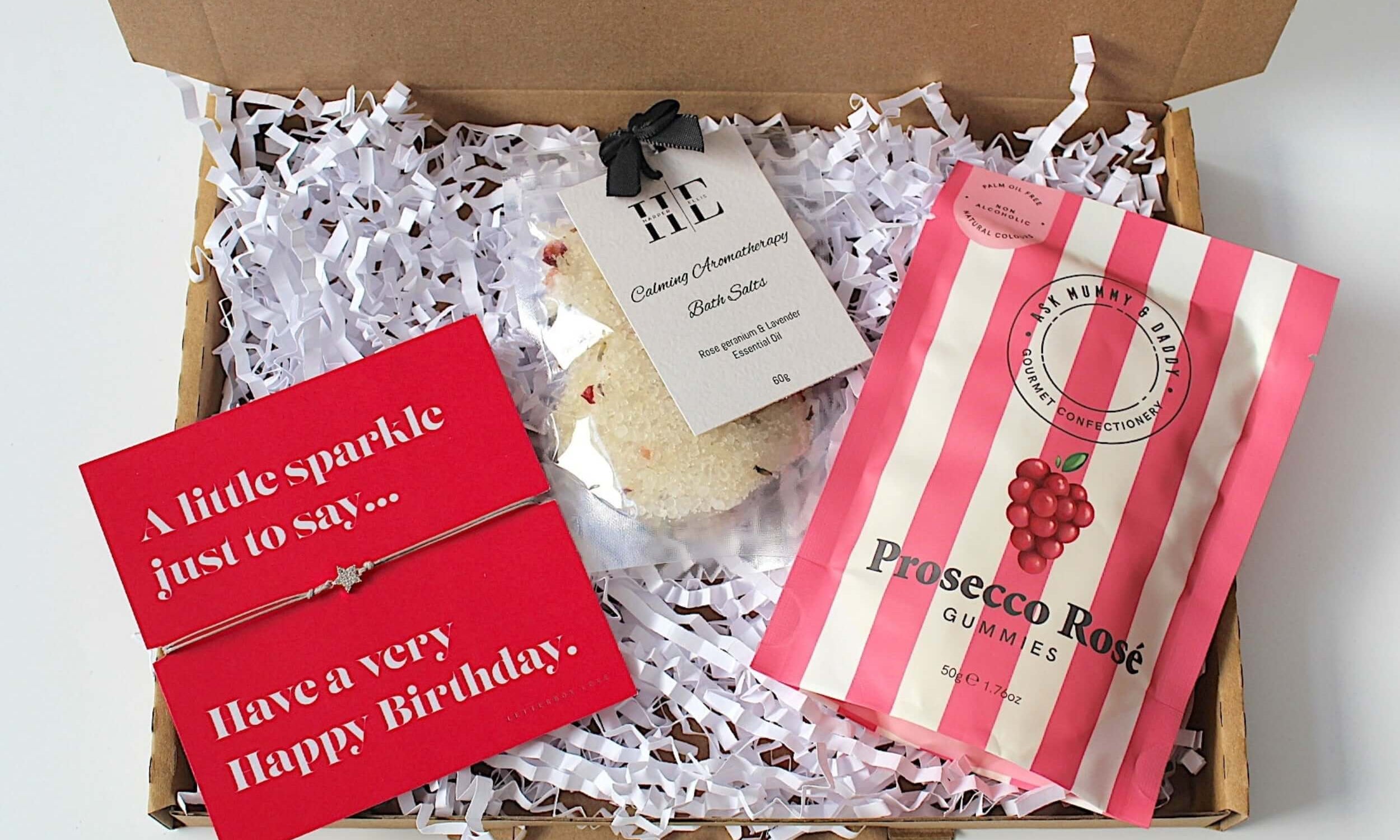 Birthday mini treat for her, this letterbox friendly gift is the perfect birthday treat, complete with adjustable bracelet, prosecco rose gummies and calming aromatherapy bath salts.  