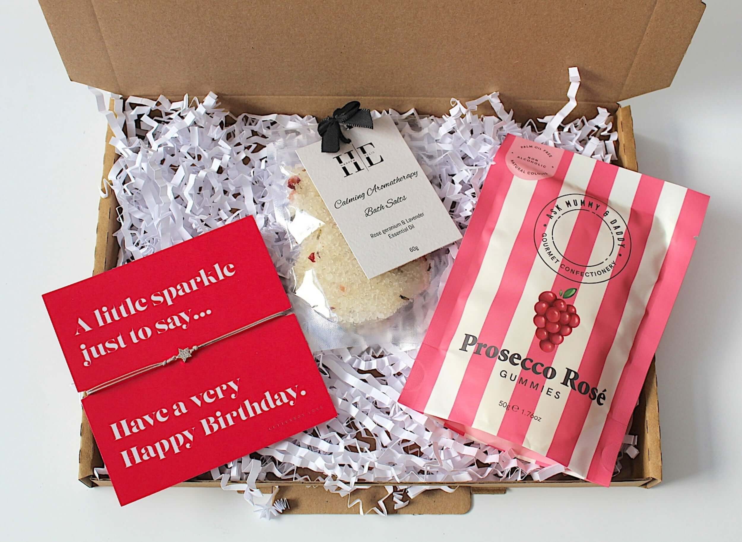 Birthday mini treat for her, this letterbox friendly gift is the perfect birthday treat, complete with adjustable bracelet, prosecco rose gummies and calming aromatherapy bath salts.  