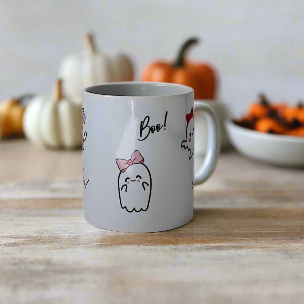 White mug with ghost illustrations and text boo