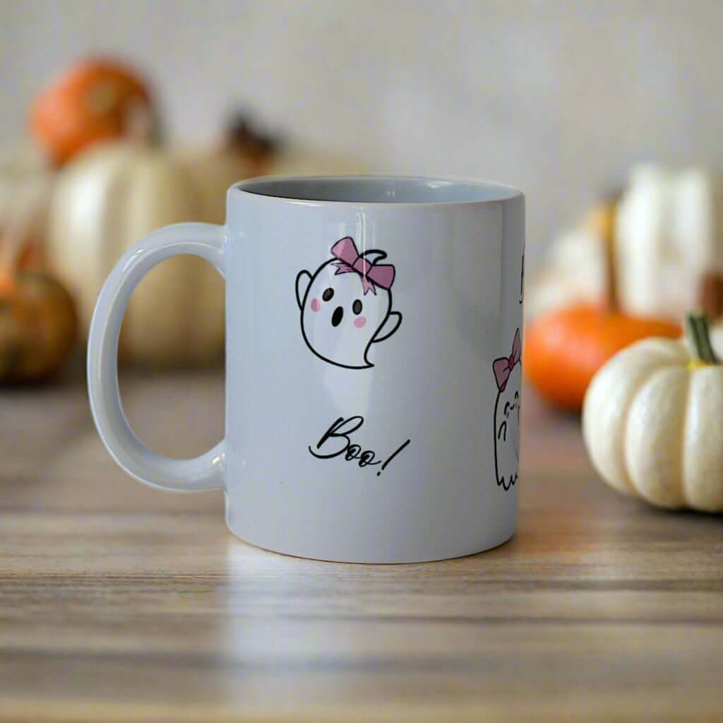 White mug with ghost design and 'Boo!' text on a gray background