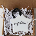 A white star-shaped ceramic ornament with 'Congratulations' written in black script.