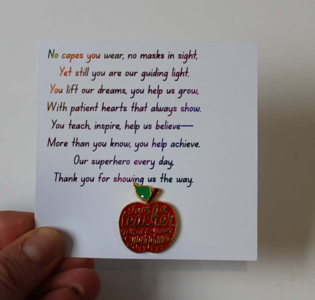 Teacher pin badge featuring an apple design displayed on an inspirational card celebrating educators.